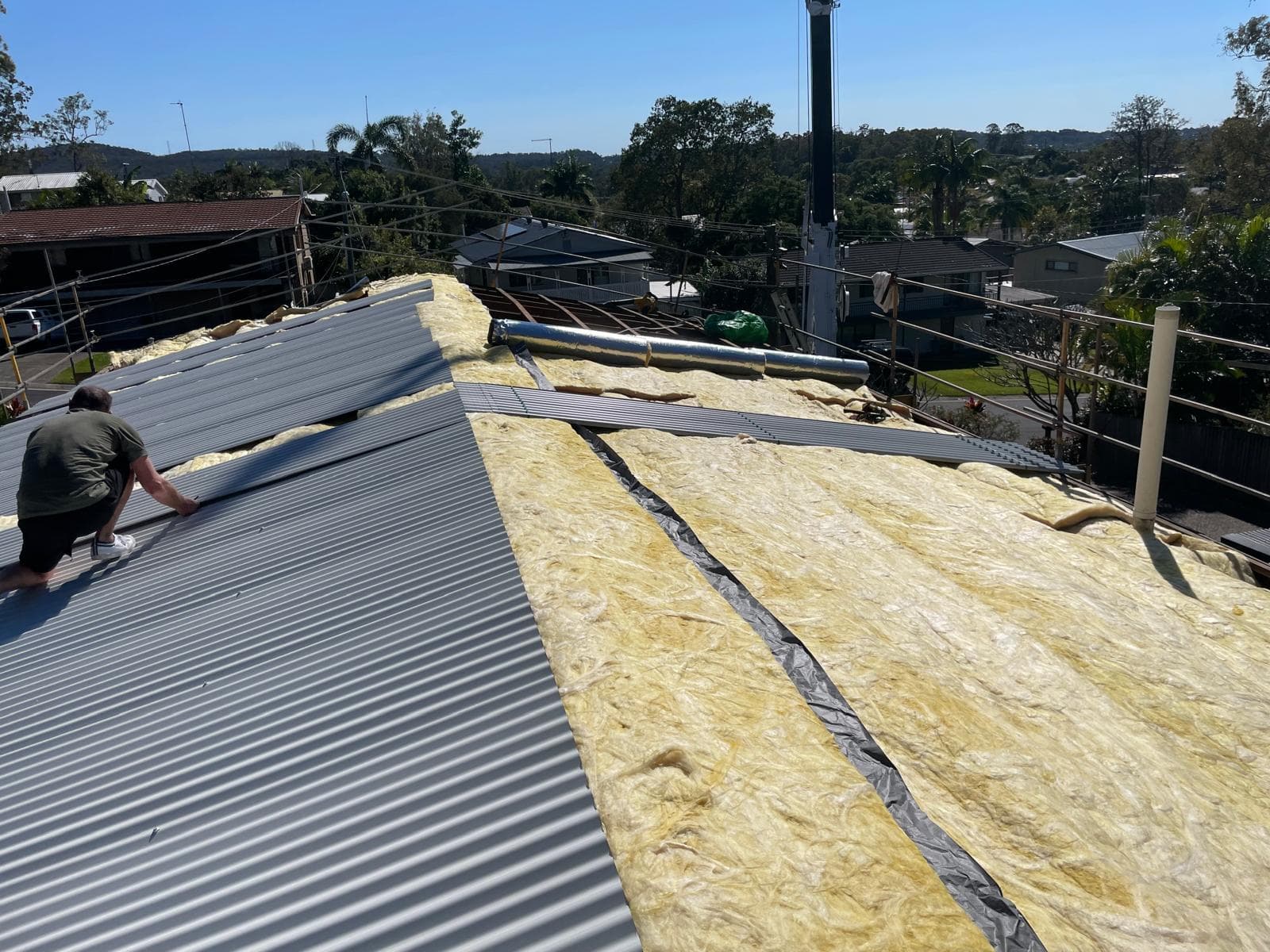 Professional roof insulation installation during asbestos replacement project in Nerang Gold Coast by CBMR roofing specialists