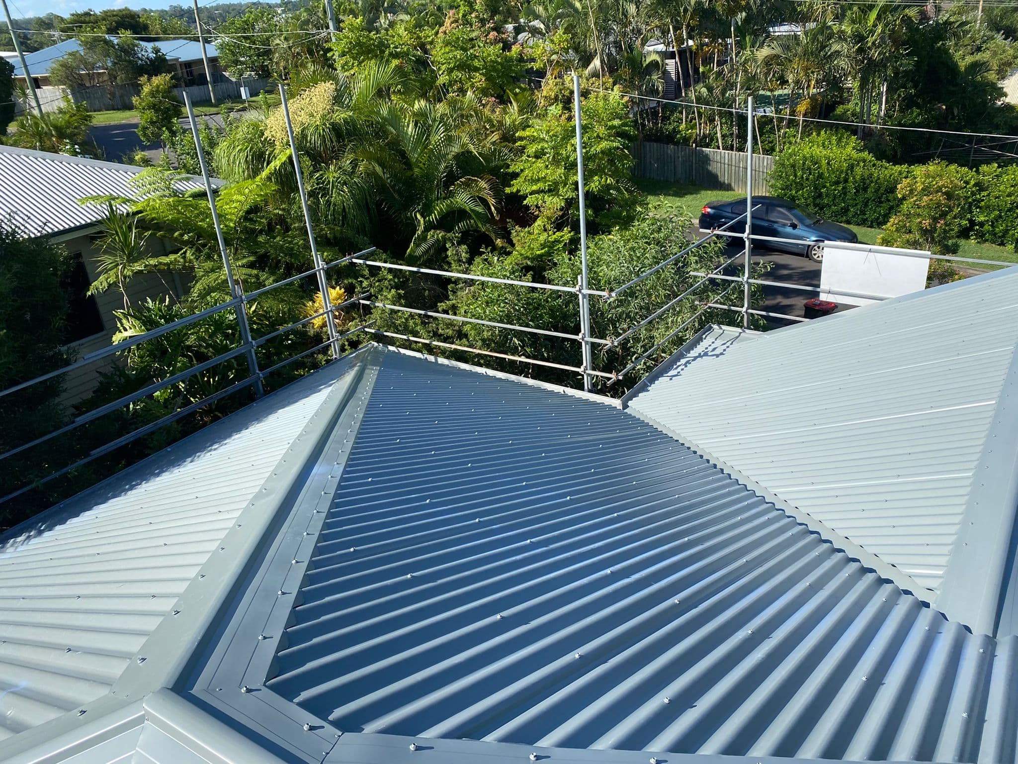 Tile roof replacement in Keperra Brisbane featuring upgrade from concrete tiles to lightweight metal roofing with improved durability and efficiency