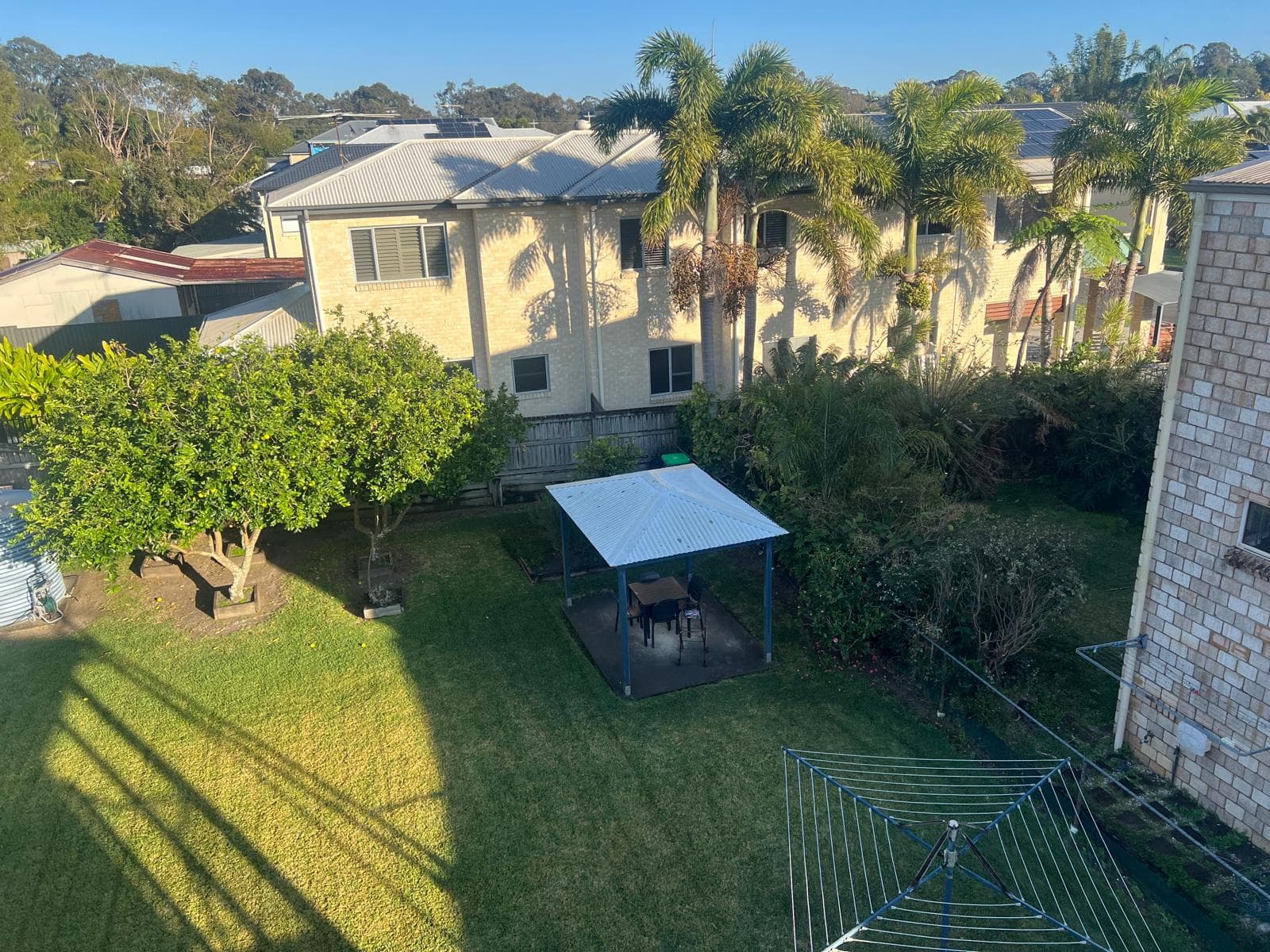 Completed metal roofs on the house and rear shed of a property in Lota, Brisbane