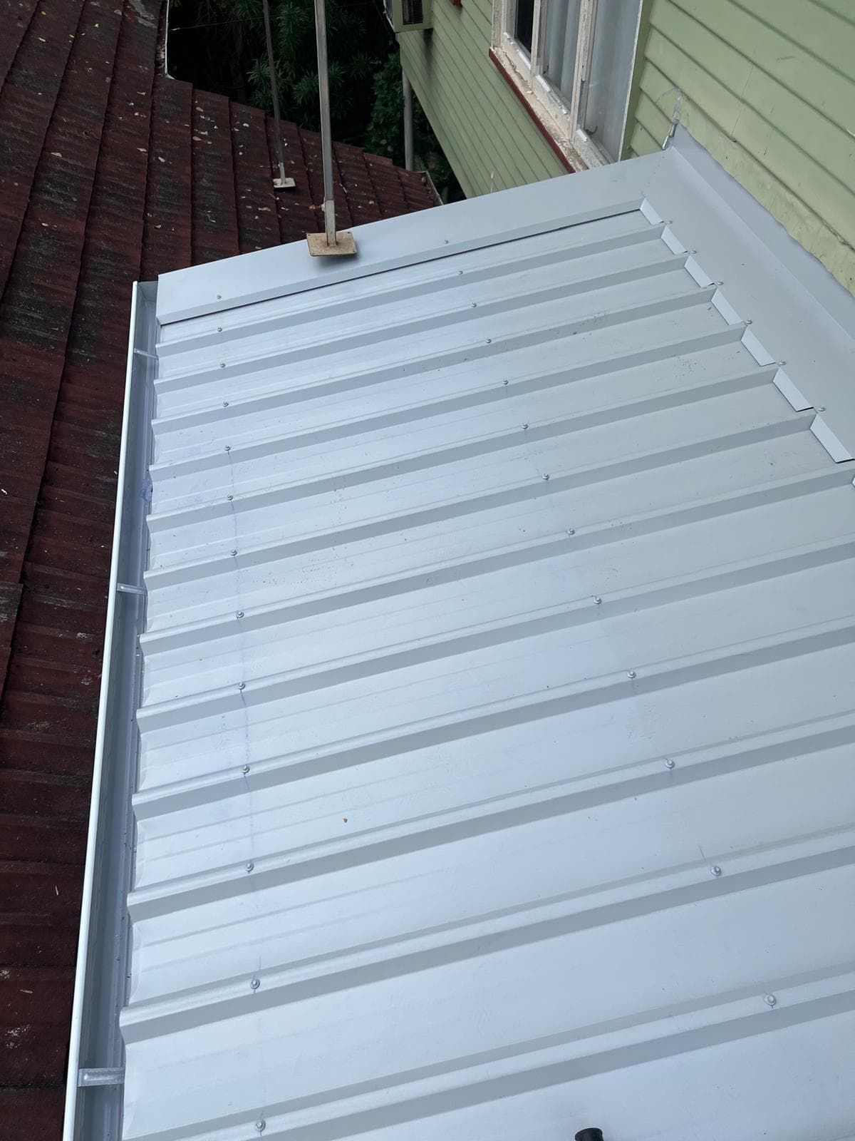 New Colorbond roof sheeting being laid on a home in The Gap, Brisbane