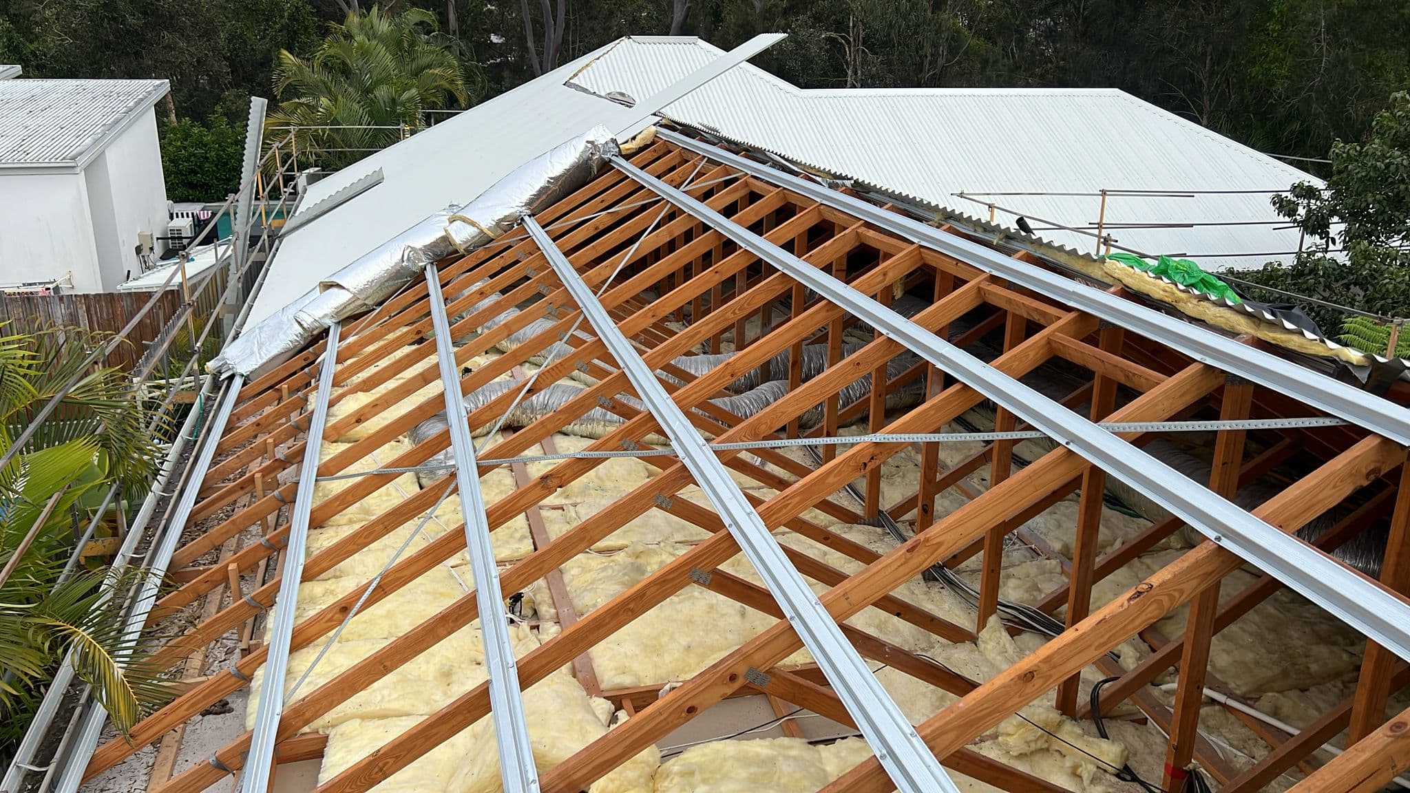Roof stripped back to the frame with new steel battens and insulation during a metal roof replacement in Wakerley, Brisbane